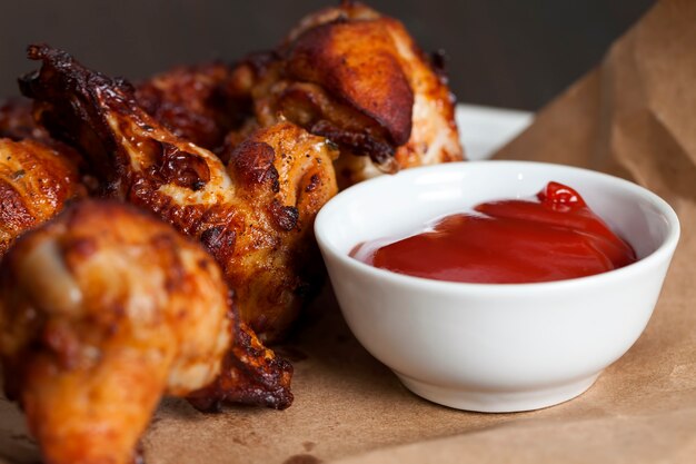 Baked chicken wings together with ketchup