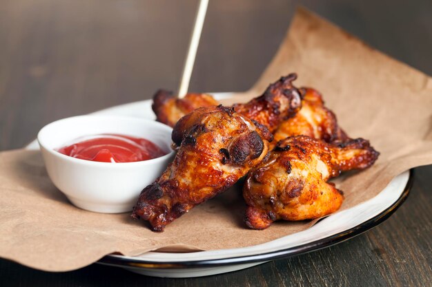 Baked chicken wings together with ketchup