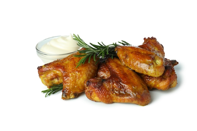 Baked chicken wings with rosemary and sauce isolated on white