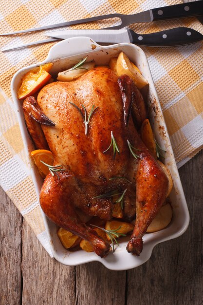 Baked chicken with apples in the baking dish closeup