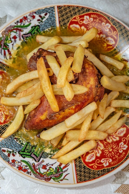 Baked chicken with french fries on a plate