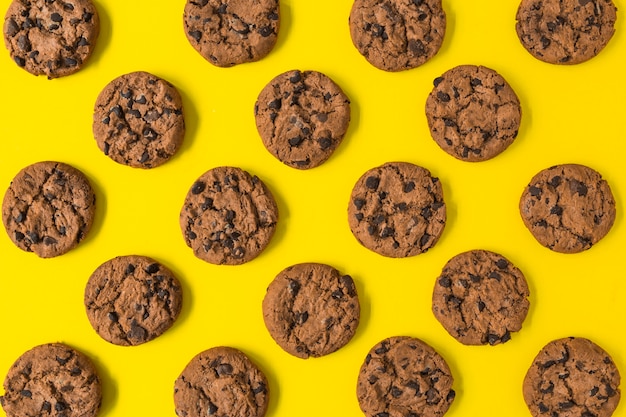 Baked chocolate cookies on yellow background