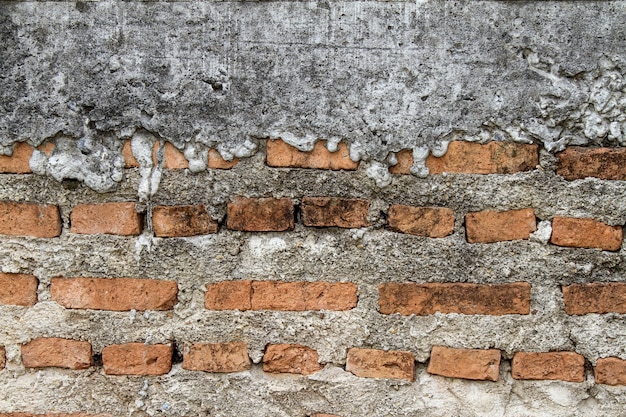 Baked clay of red brick in cement for wall 