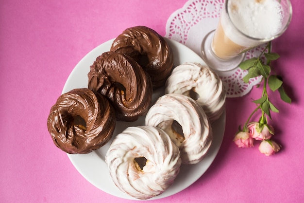 Baked cookies chocolate donuts on pink background