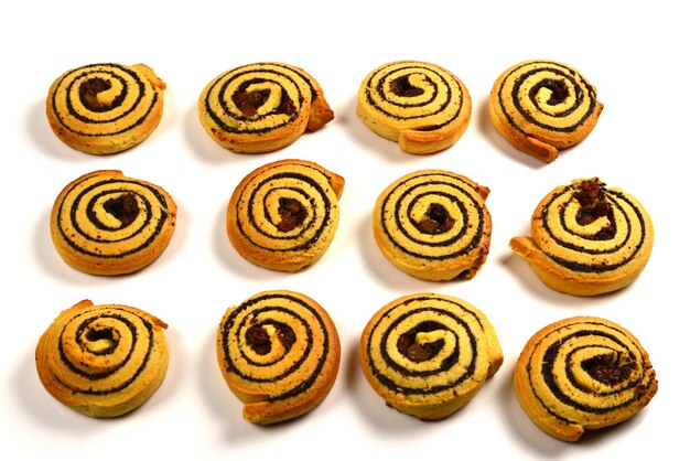 Baked cookies with raisins and poppy seeds isolated on white background.