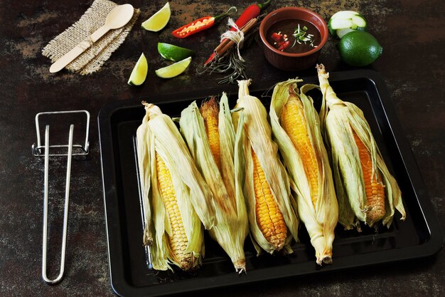 Baked corn in leaves on a pan