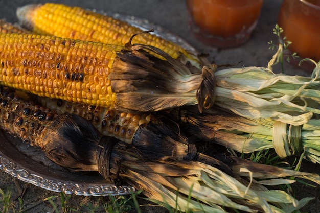 Baked corn and potatoes on the grill