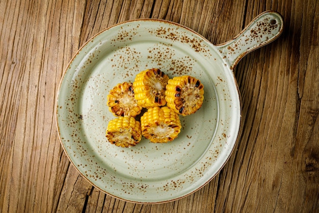 baked corn on a wooden black table