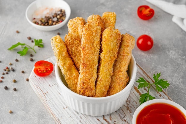 Baked crispy garlic parmesan zucchini sticks served with tomatoes sauce Vegetarian healthy dish