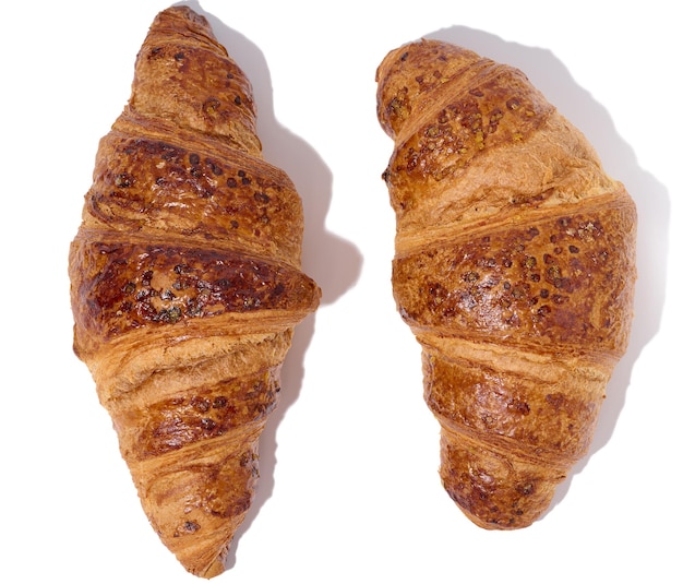Baked croissant on a white isolated background top view