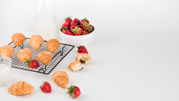 Baked croissants and strawberries with copy space