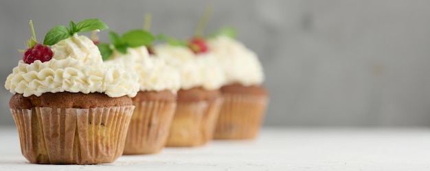 Baked cupcakes with white butter cream on the table delicious dessert