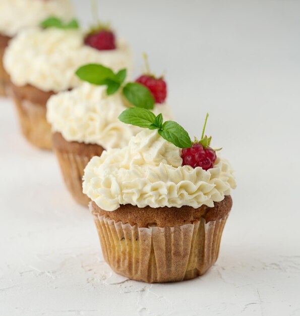 Baked cupcakes with white butter cream on the table delicious dessert