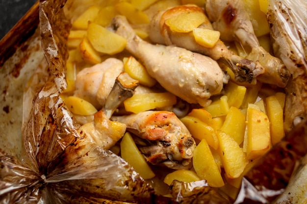 Baked delicious rabbit with potatoes and carrot in a rustic style Baked rabbit