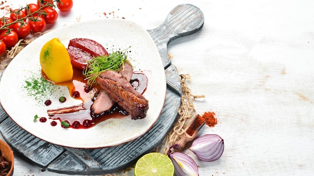 Baked duck fillet with pear and cranberry sauce Top view free space for your text Rustic style