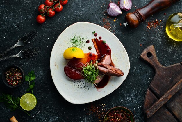 Baked duck fillet with pear and cranberry sauce Top view free space for your text Rustic style