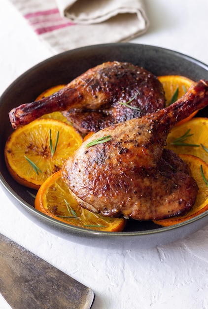 Baked duck legs with oranges and rosemary Rustic style