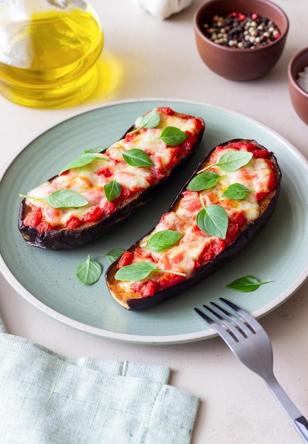 Baked eggplant with cheese mozzarella tomatoes and basil\
healthy eating italian food parmigiana di melanzane