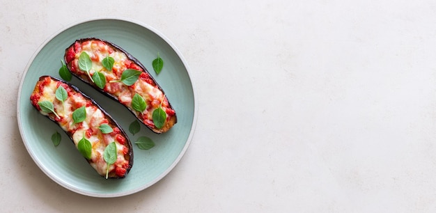 Baked eggplant with cheese mozzarella tomatoes and basil Healthy eating Italian food Parmigiana di melanzane