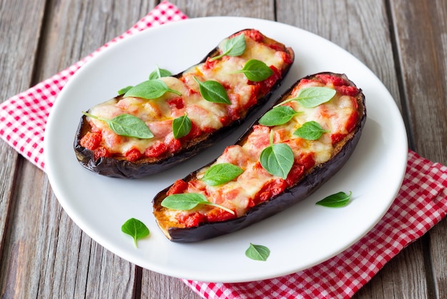 Baked eggplant with cheese mozzarella tomatoes and basil Healthy eating Italian food Parmigiana di melanzane