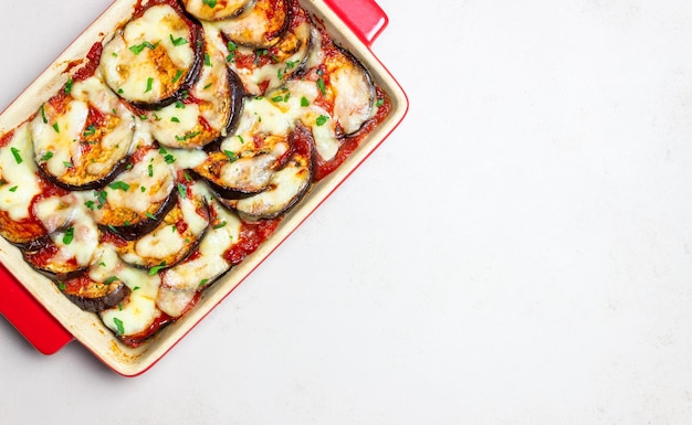 Baked eggplant with cheese mozzarella and tomatoes Healthy eating Italian food Parmigiana di melanzane