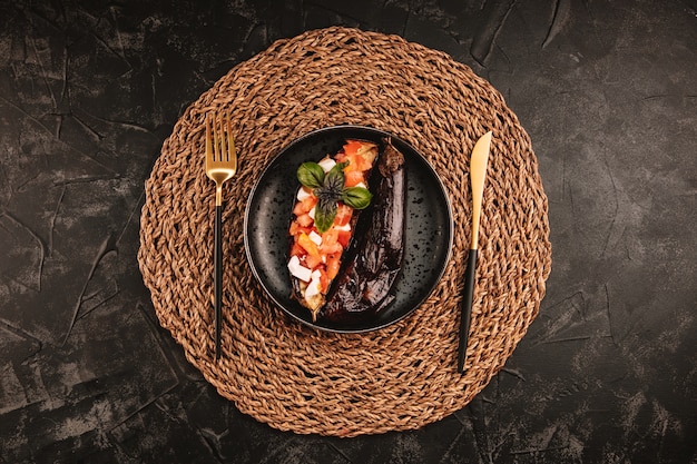 Baked eggplant with tomato salad, feta cheese and basil