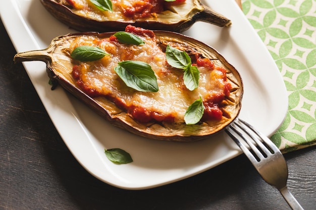 Baked eggplant with tomatoes and mozzarella and basil