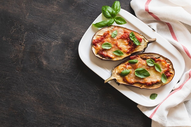 Baked eggplant with tomatoes and mozzarella and basil