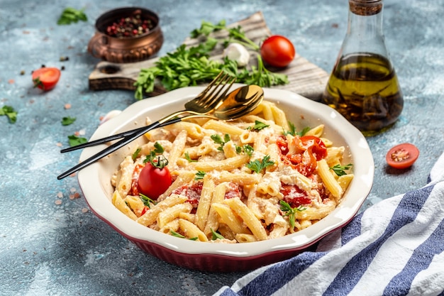 Baked feta pasta with cherry tomatoes, olive oil and herbs