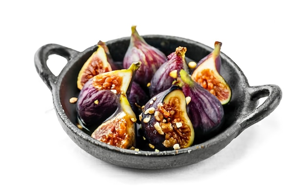 Baked figs with cream cheese honey and nuts Isolated on white background