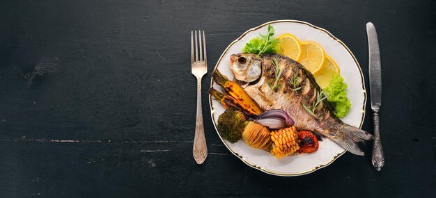 Baked fish carp On a wooden background Top view Copy space