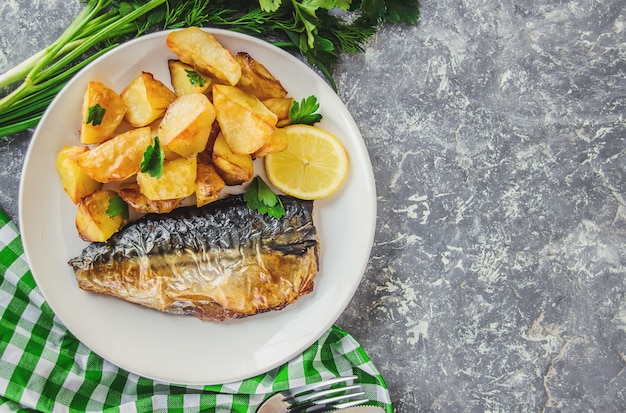 Baked fish mackerel and potatoes. Selective focus.