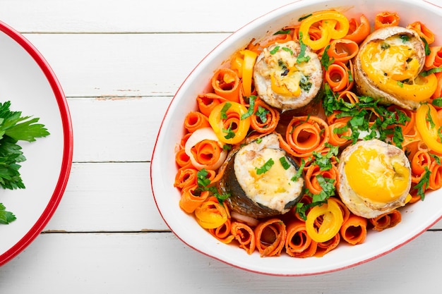 Baked fish rolls with cheese,carrots and pepper.