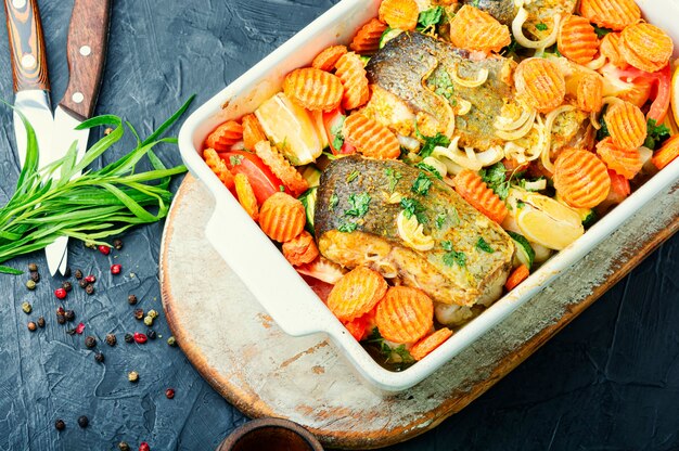 Baked fish steaks with grilled vegetables in baking dish.Delicious healthy grilled fish
