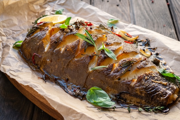 Baked flounder fish whole with seasonings, lemon and Basil on parchment