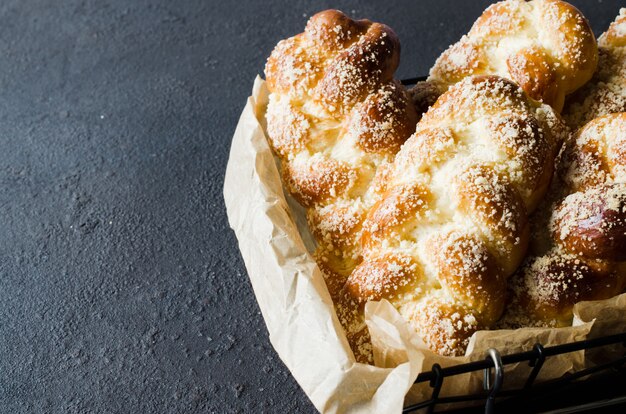 Baked fresh fragrant buns. Traditional homemade pastries. Pigtail buns top view.