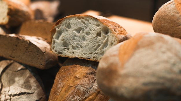 Baked fresh white and rye bread in shop window Closeup selective soft focus