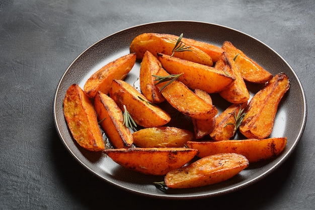 Baked fried  potato  wedges with spices and rosemary