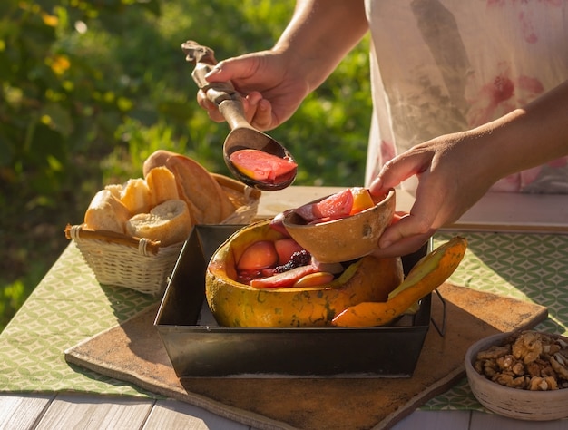 Baked fruit and berries in a pumpkin. Food on the nature. The concept. Healthy food