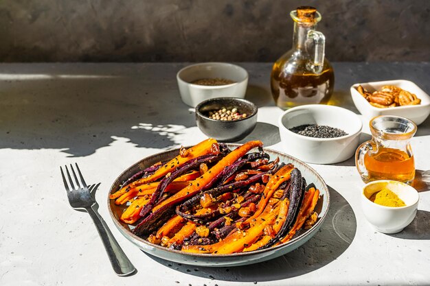 Baked glazed spicy carrots Moroccan inspired made with olive oil honey spices sesame seeds