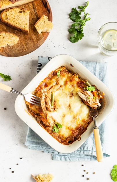 Baked gratin with chicken, vegetables in a tomato sauce with cheese. 