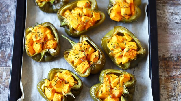 Baked green peppers stuffed with pumpkin.