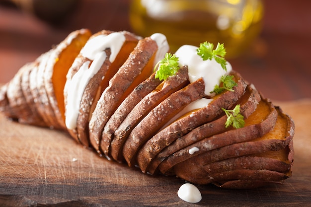 Baked hasselback potato with sour cream