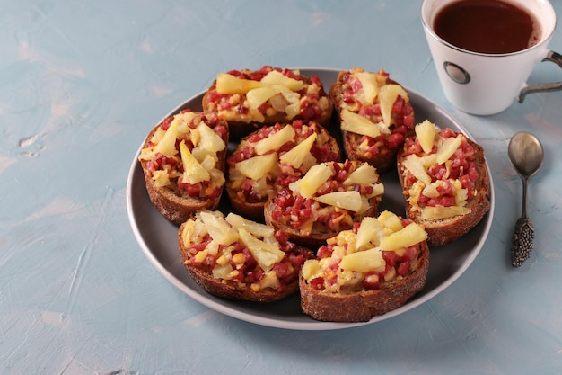 Baked homemade hot sandwiches with sausage cheese and pineapple Delicious breakfast or snack