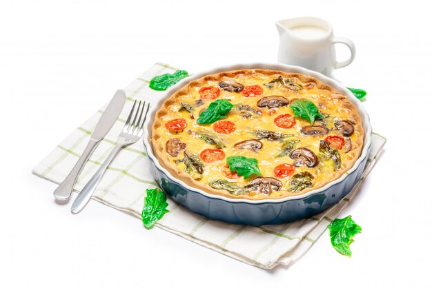 Baked homemade quiche pie in ceramic baking form