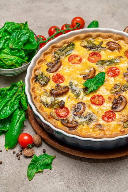 Baked homemade quiche pie in ceramic baking form