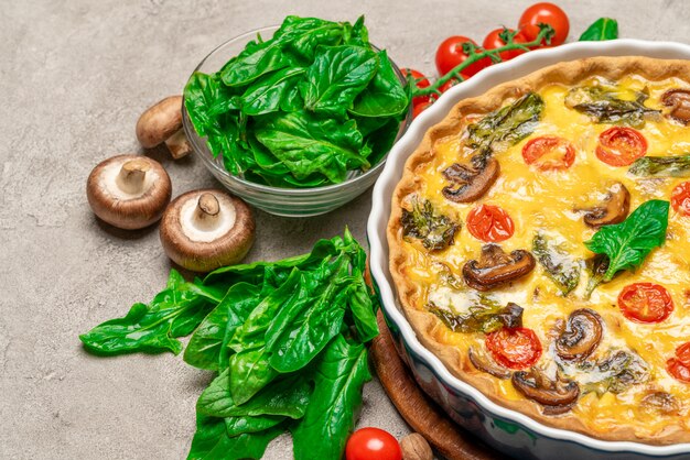 Baked homemade quiche pie in ceramic baking form