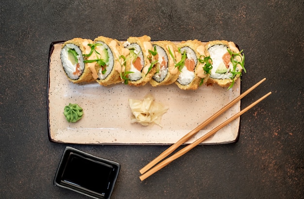 石の背景に焼きたての日本の巻き寿司はすぐに食べられます