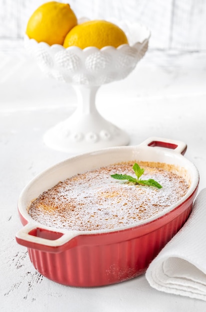 Baked Lemon Pudding garnished with powdered sugar and mint