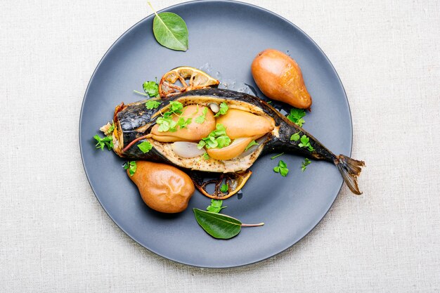 Baked mackerel fish stuffed with autumn pear.Seafood